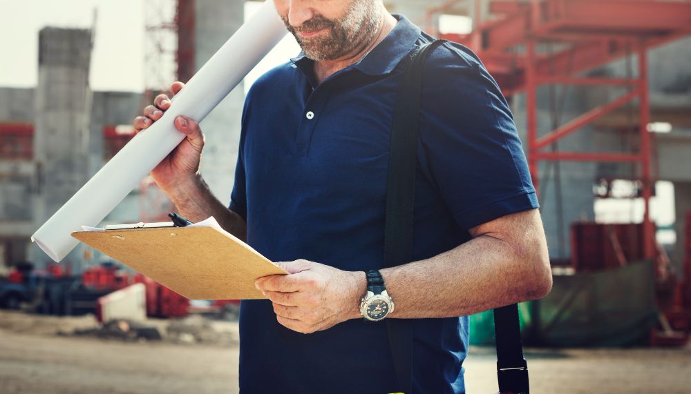 Site engineer reviewing construction project details on site