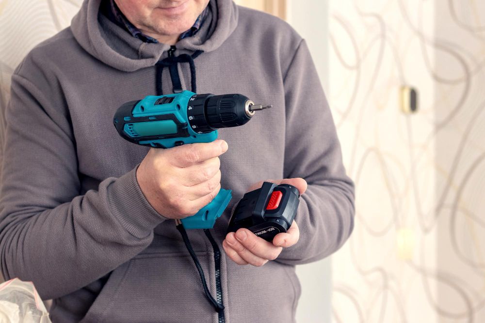Handyman using a cordless screwdriver during installation work