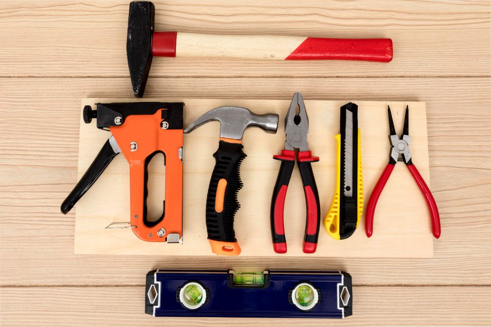 Flat lay of professional handyman tools arranged on a workbench
