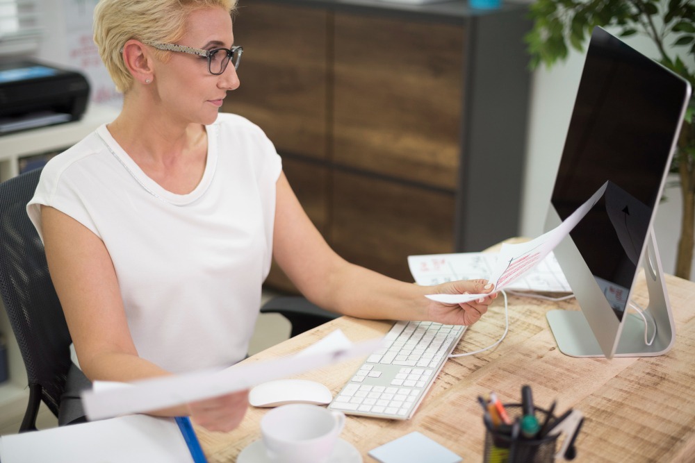 accountant doing invoice reconciliation at desk