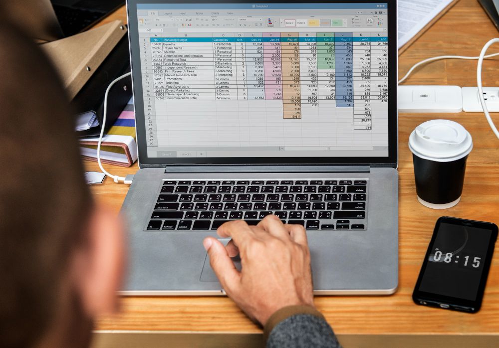 accountant updating invoice tracker excel template