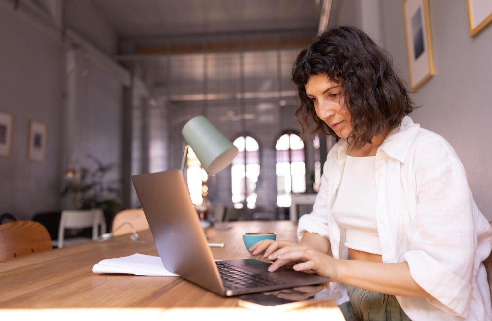 small business owner using invoice tracking dashboard on laptop


