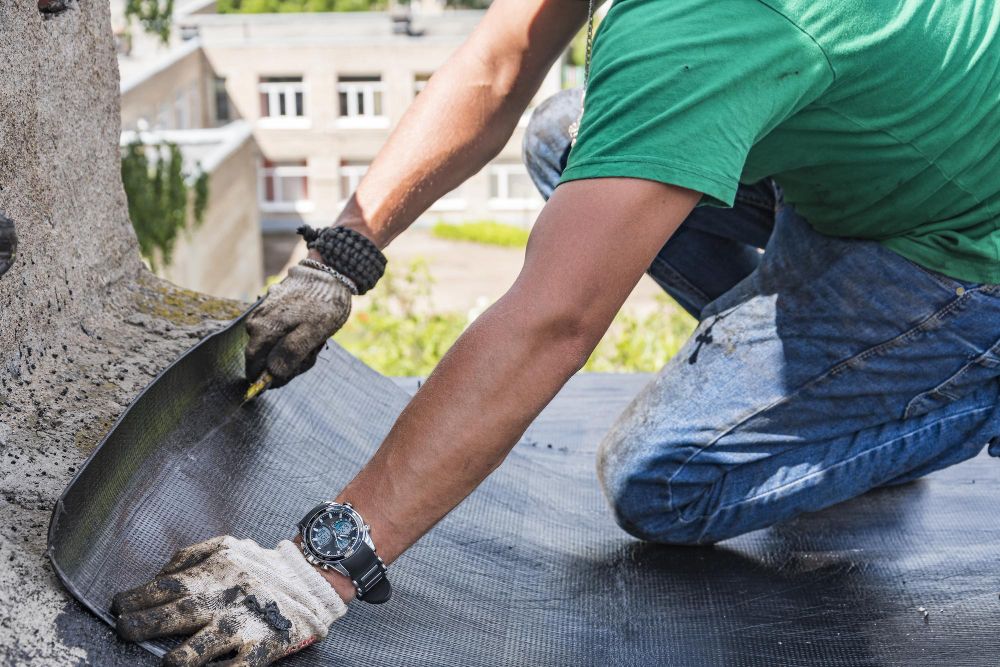 Roofing worker performing repairs on residential roof