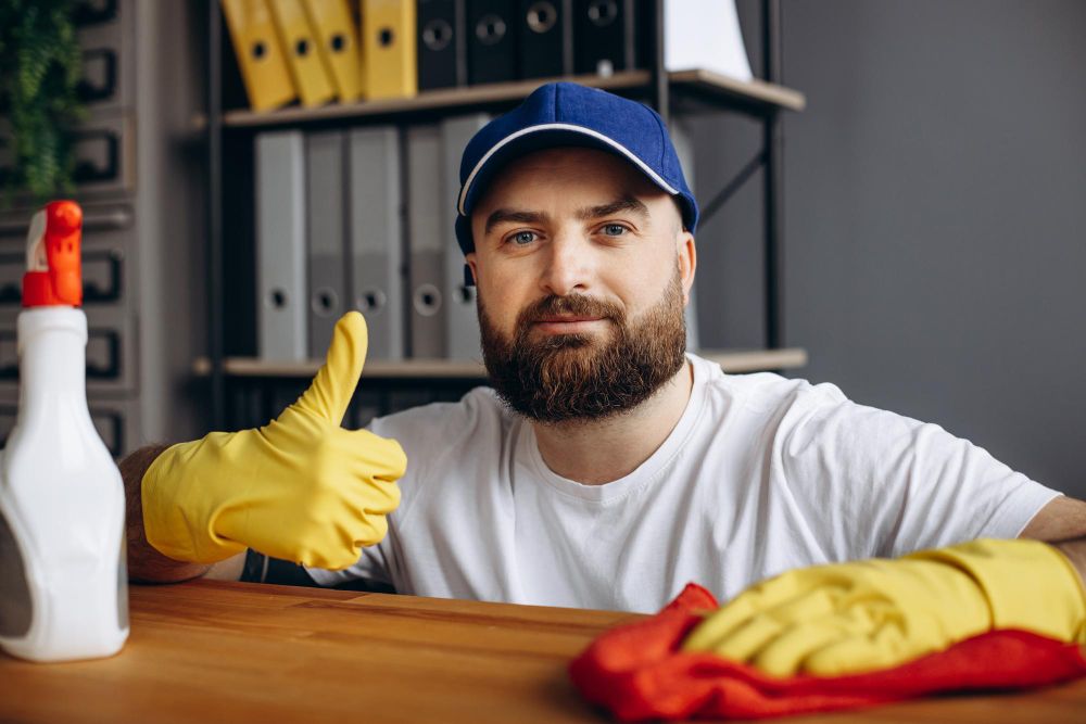 Cleaning professional disinfecting a kitchen countertop