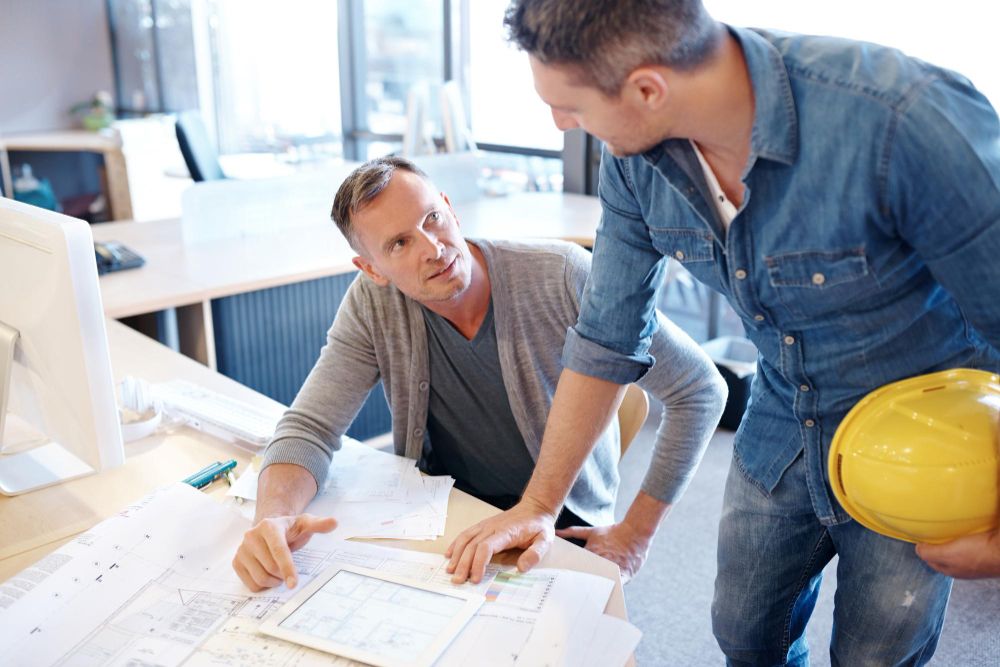 Construction professionals reviewing project blueprints
