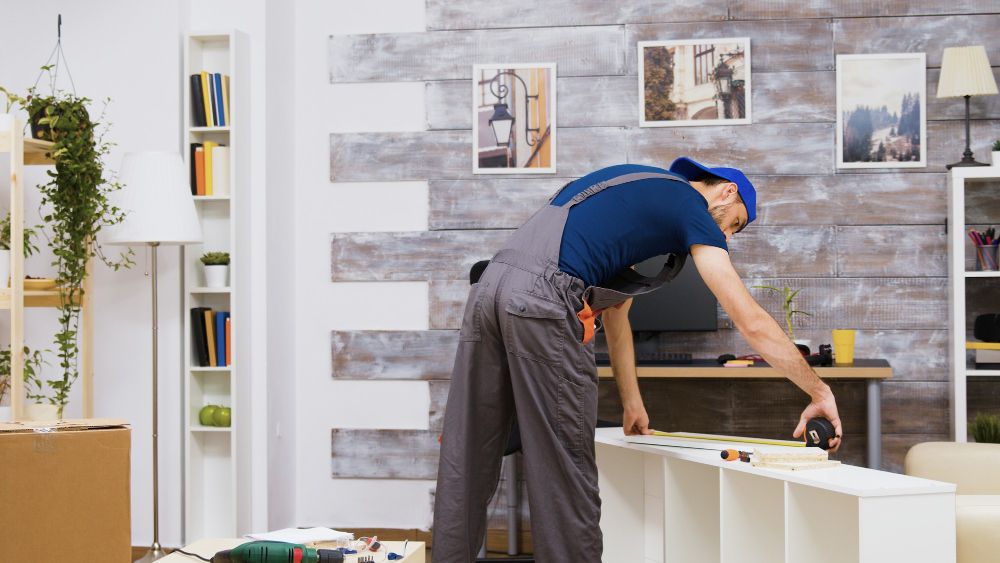 Handyman assembling furniture with tools
