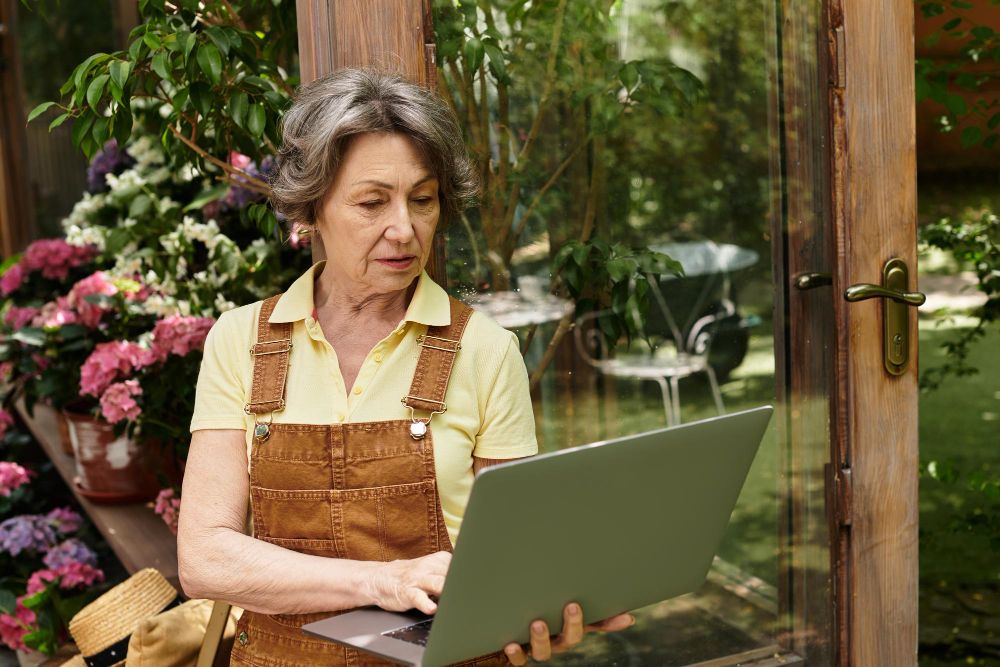 Business owner using a laptop to manage landscaping operations