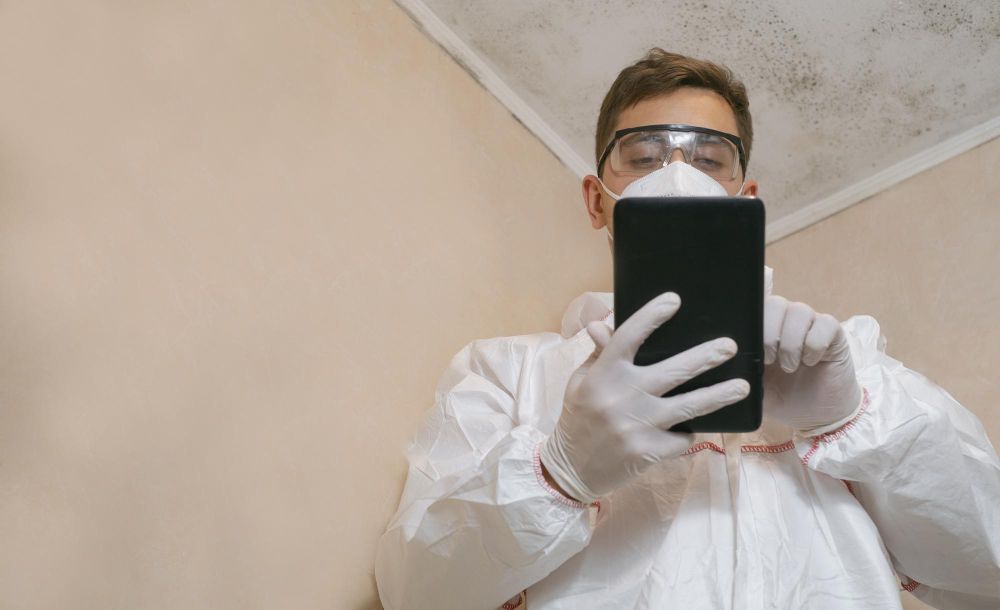 Pest control technician documenting a property inspection on a phone