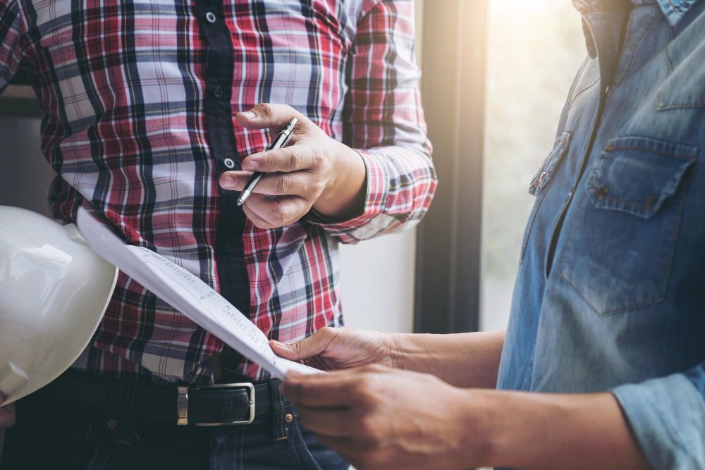 Contractors reviewing project documents together