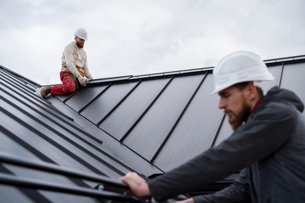 Roofing crew installing materials on a flat roof