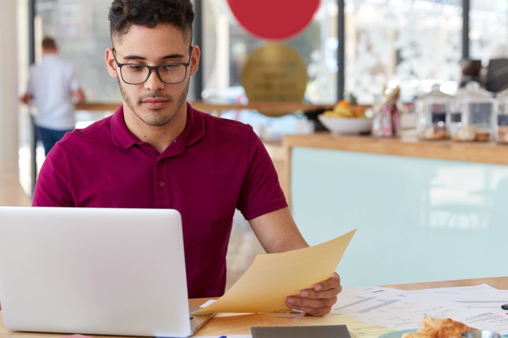 small business owner reviewing outstanding invoices on laptop