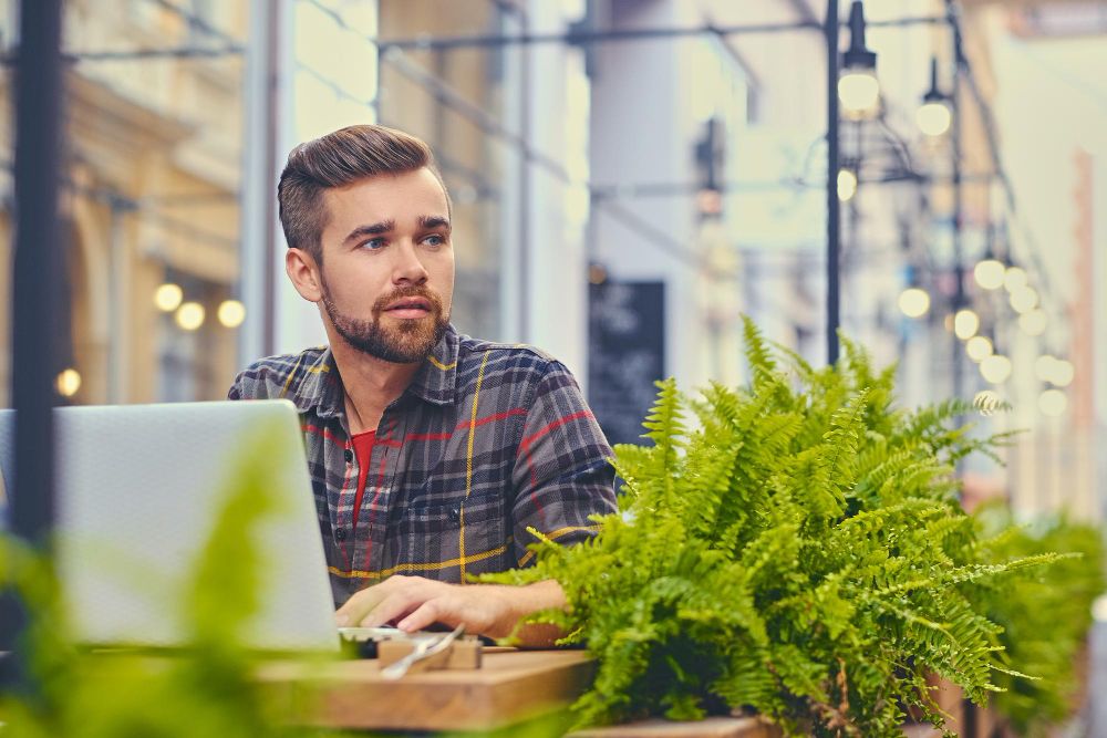 Tree service business owner managing leads on a laptop