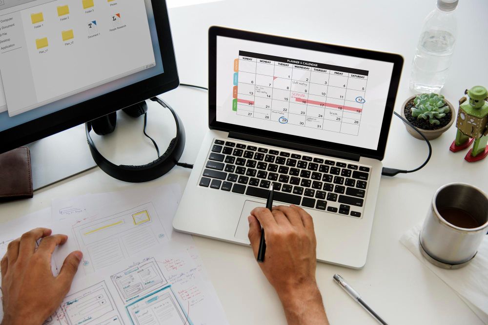 cleaning business app showing schedule and client list on laptop
