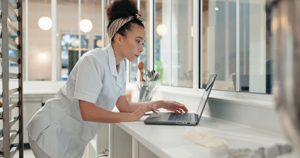 Cleaning business owner working on a laptop
