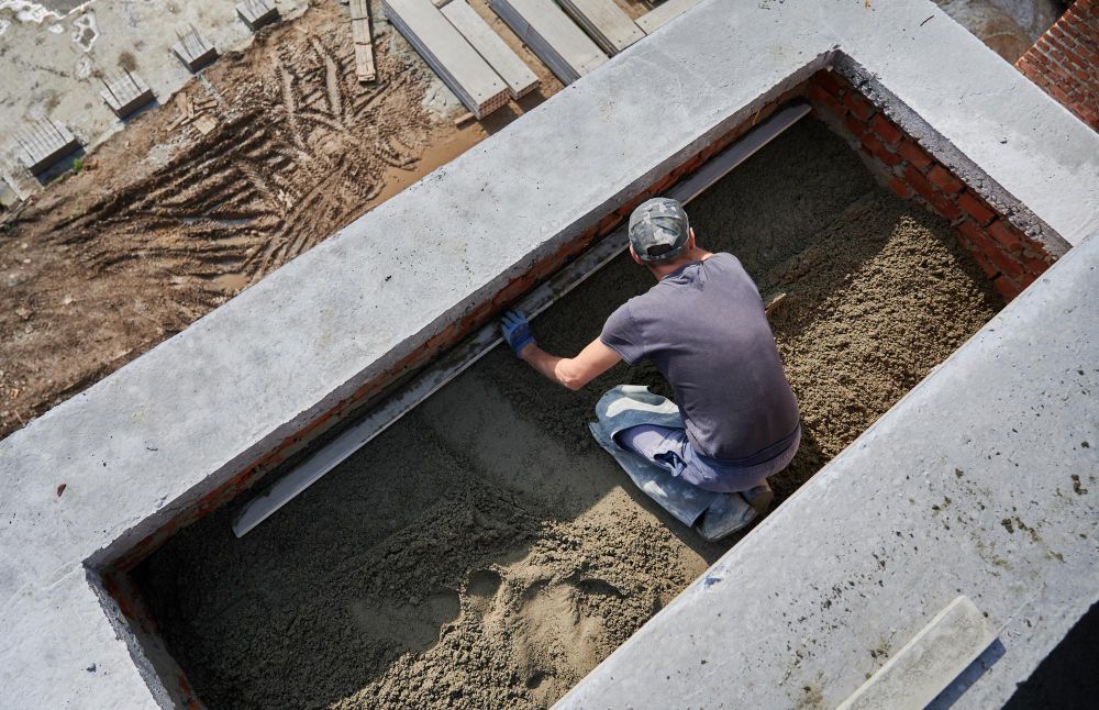 Construction worker finishing freshly poured concrete