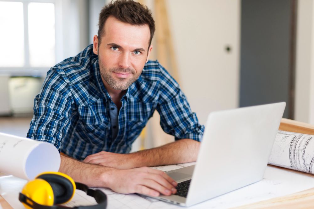 Construction business owner using a laptop to manage leads