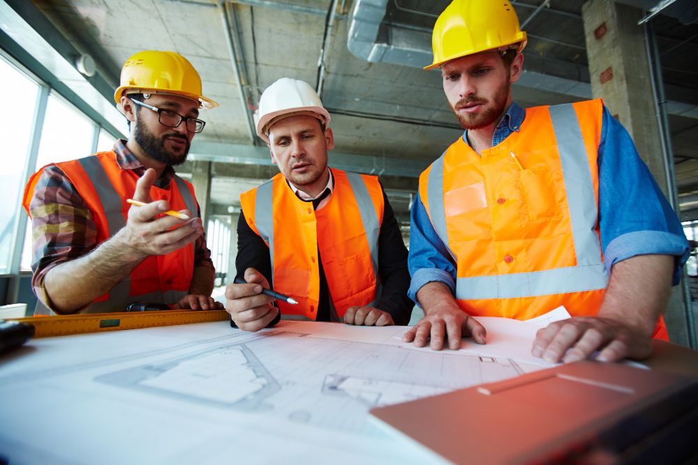 Construction engineers discussing a project on site