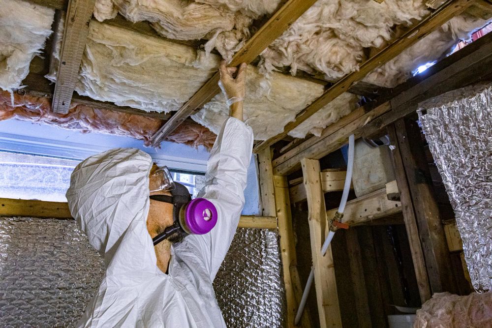 Contractor repairing a damaged ceiling structure
