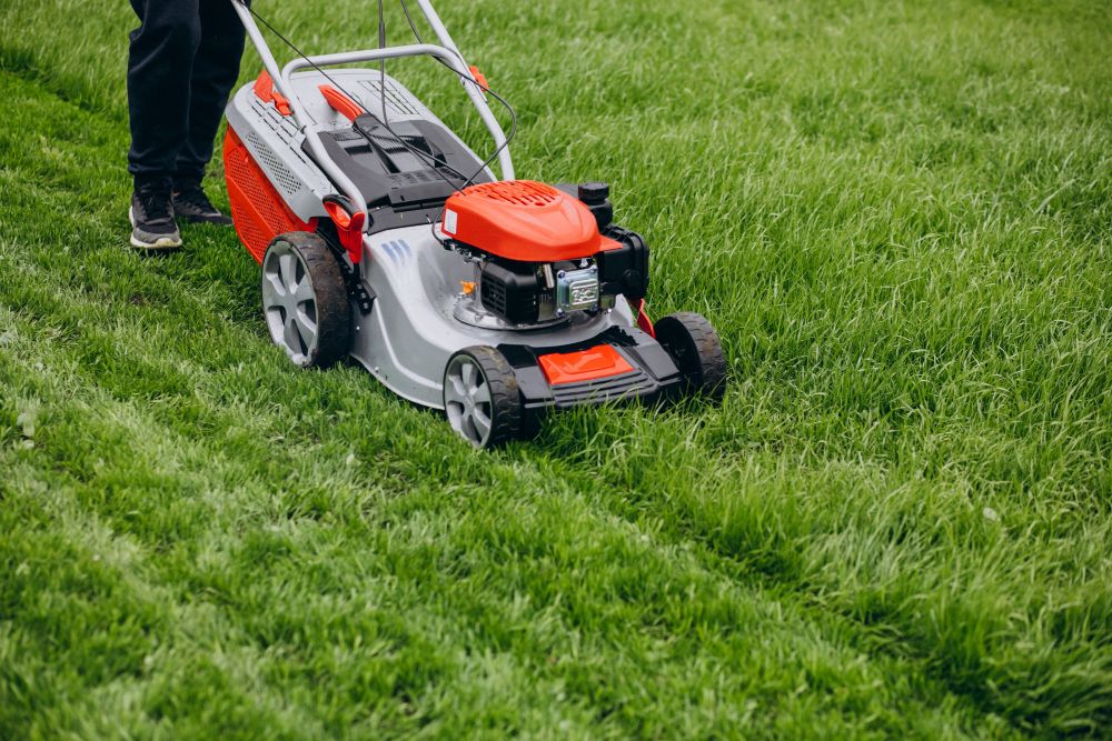 landscaping technician mowing lawn with professional equipment