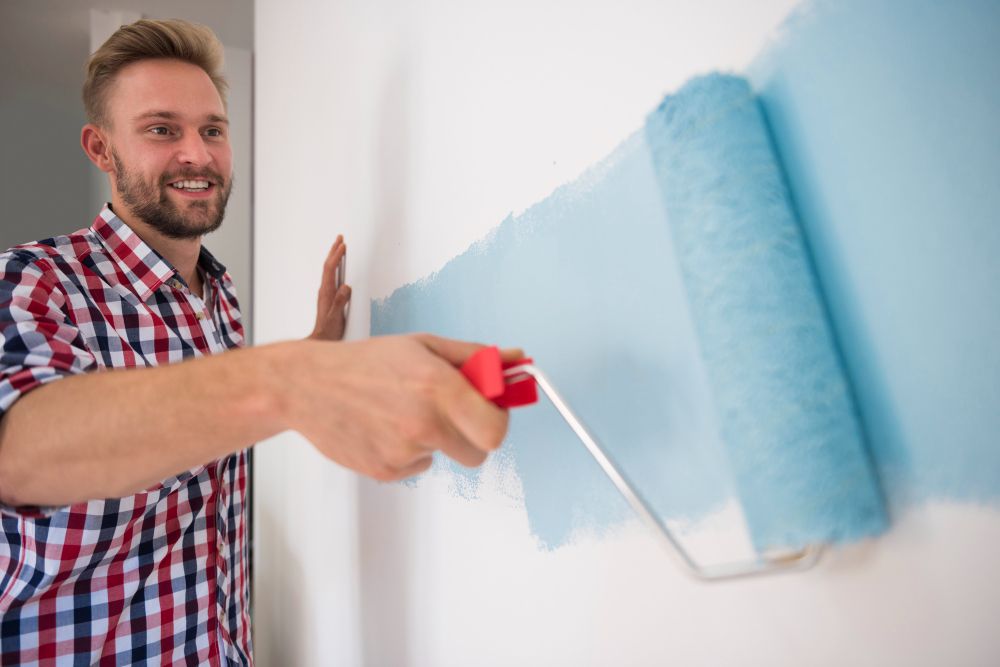 painter job description applying paint with roller indoors