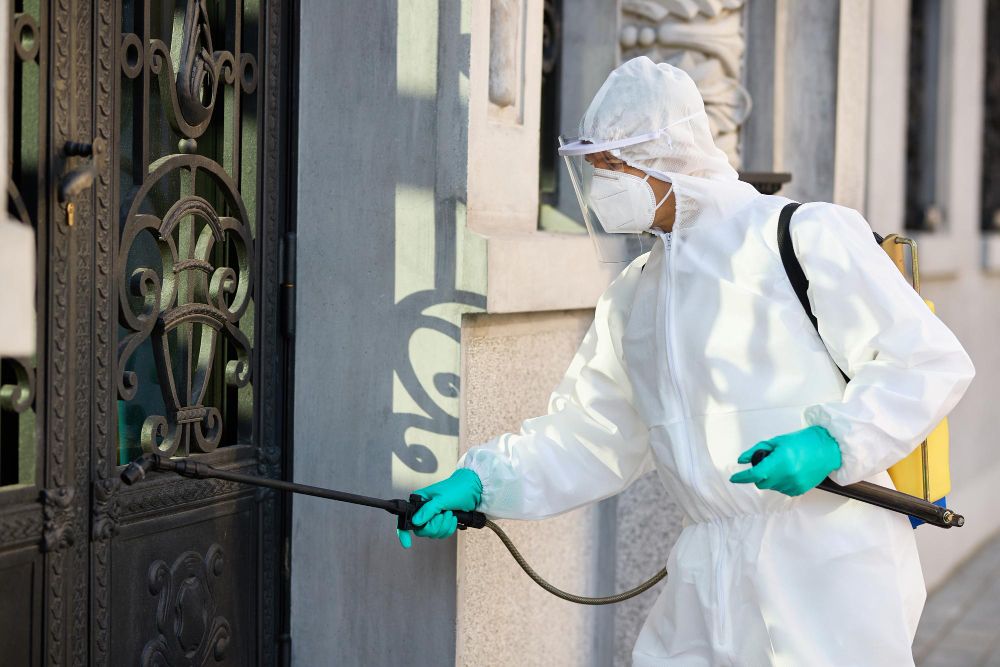Technician disinfecting an outdoor public area