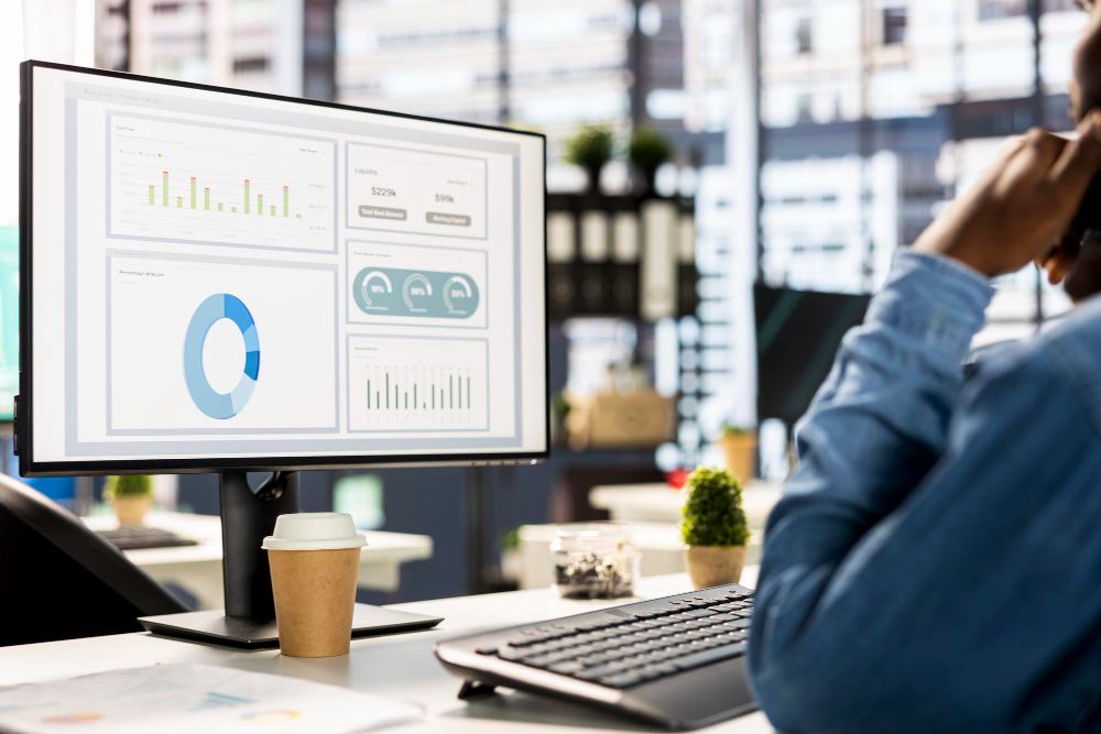 Business owner reviewing software performance metrics