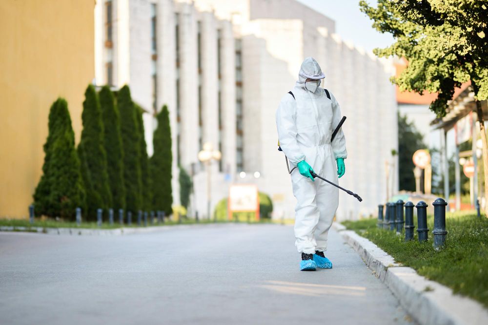 Pest control technician carrying out an outdoor treatment
