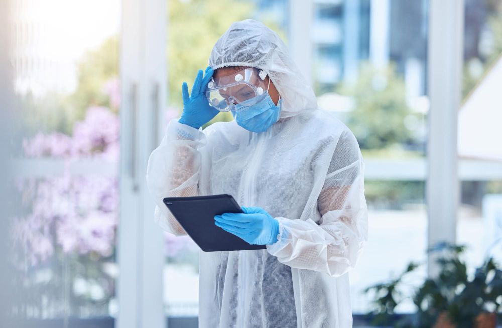 Pest control technician reviewing inspection information on a tablet