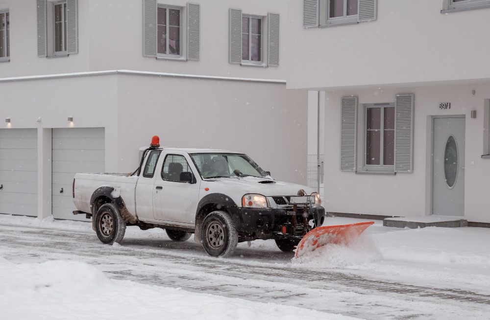 snow plowing insurance protecting truck and business while clearing parking lot