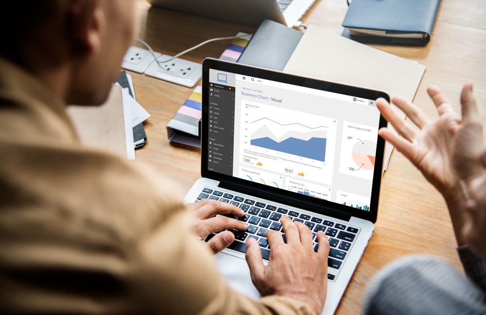 Business team reviewing marketing performance on a laptop
