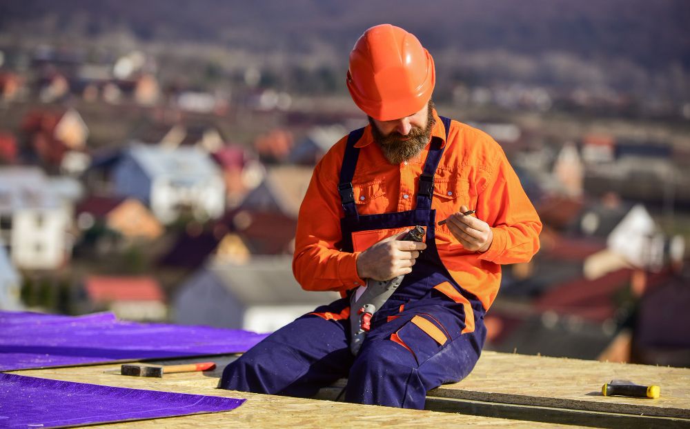 Roofer installing insulation on a flat roof