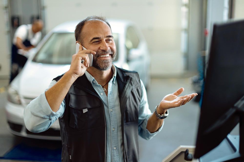 mechanic talking on the phone at service desk