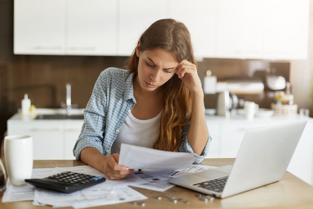 woman reviewing household bills and expenses