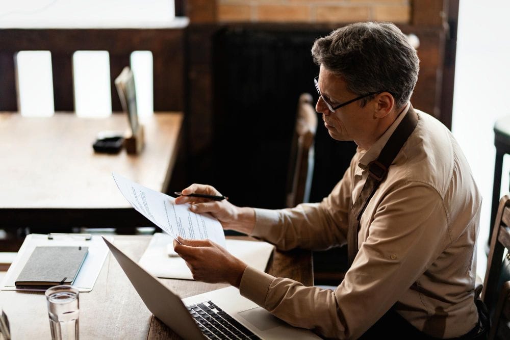 Contractor business owner reviewing paperwork and financial reports