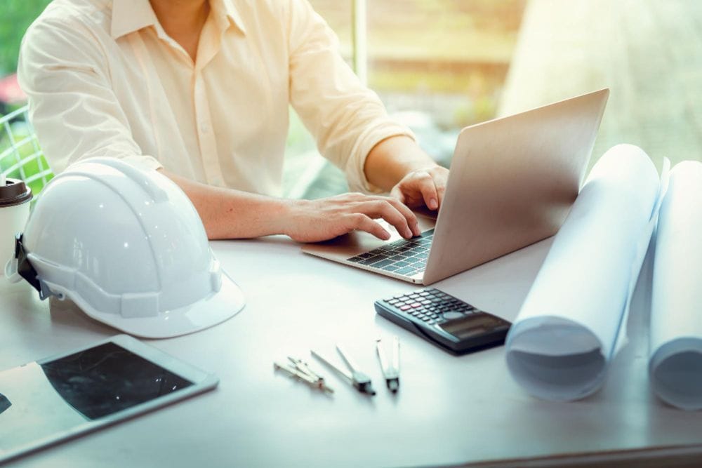 Contractor using a laptop to manage financial and business tasks