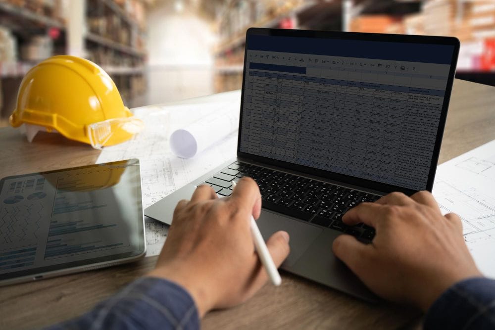 Contractor using a laptop and Invoice Fly vs Harvest to manage invoices and business records
