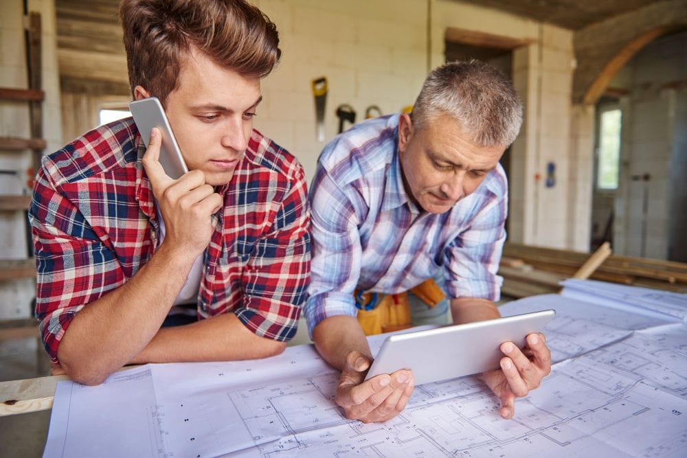 Two carpenters collaborating on a construction project