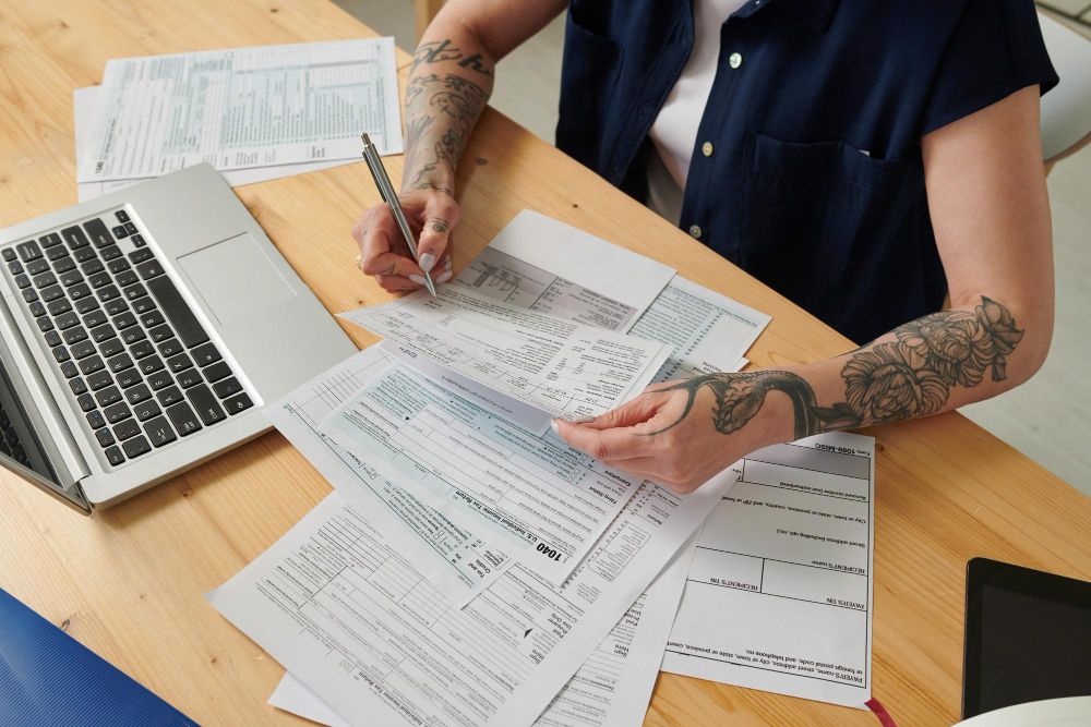 contractor reviewing forms beside laptop