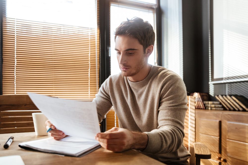 freelancer reviewing printed business documents