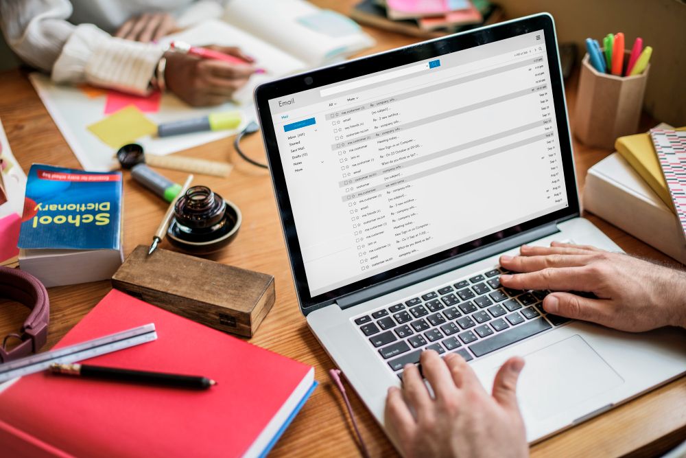 professional managing email on a laptop