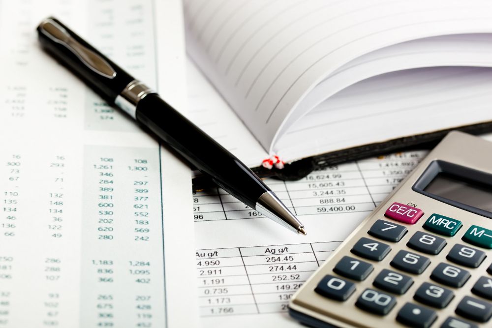 calculator and financial records on desk