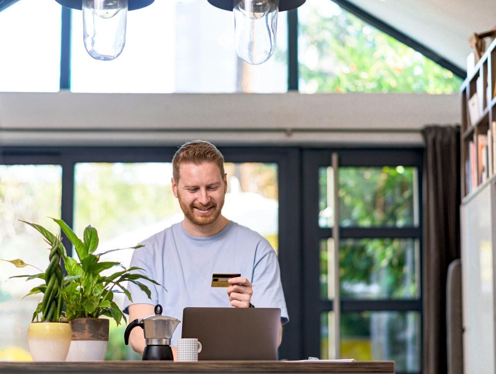 Freelancer making an online payment with a laptop and card