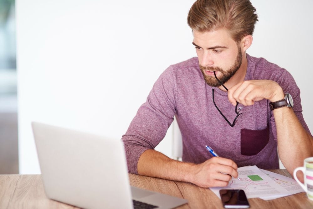 Freelancer reviewing work records and billable hours on a laptop