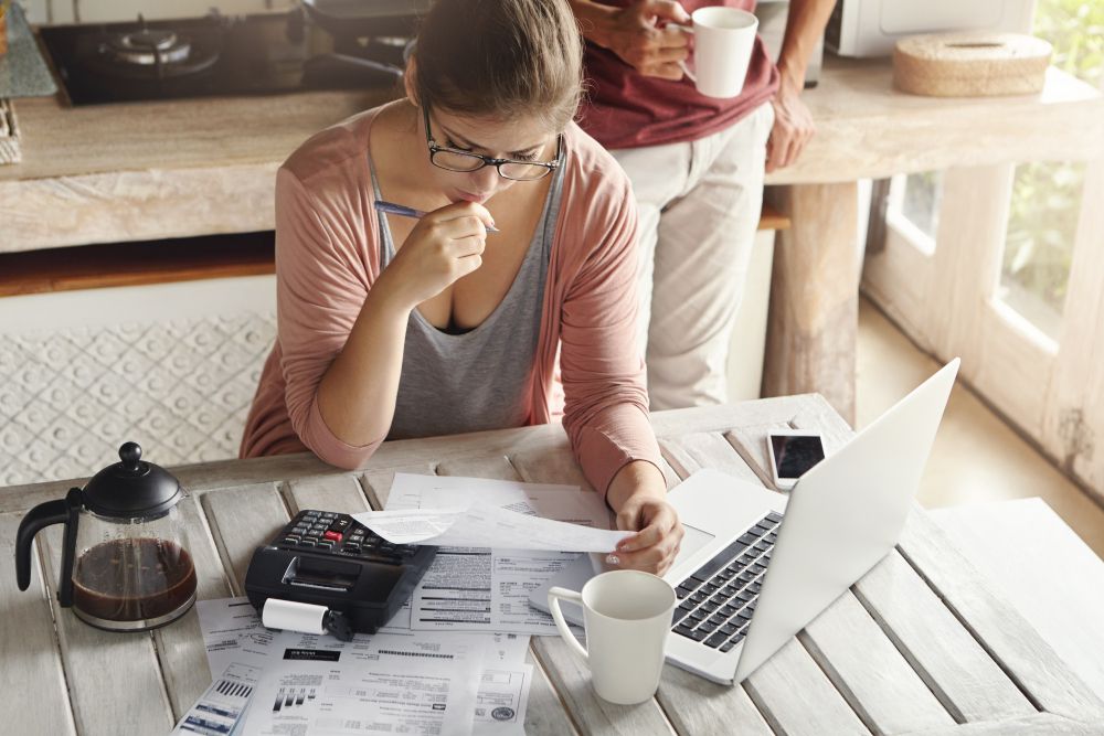woman reviewing household bills and expenses