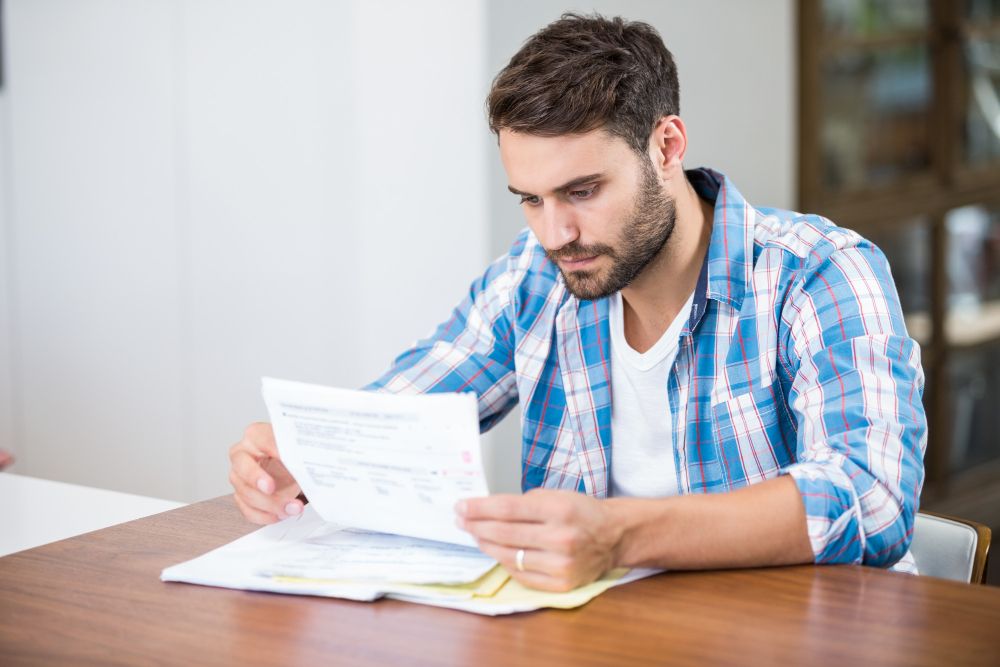 contractor reviewing printed invoice documents