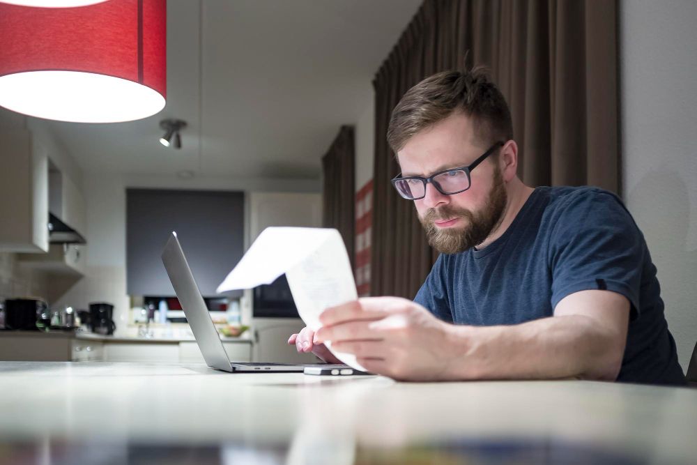 freelancer reviewing an invoice at home