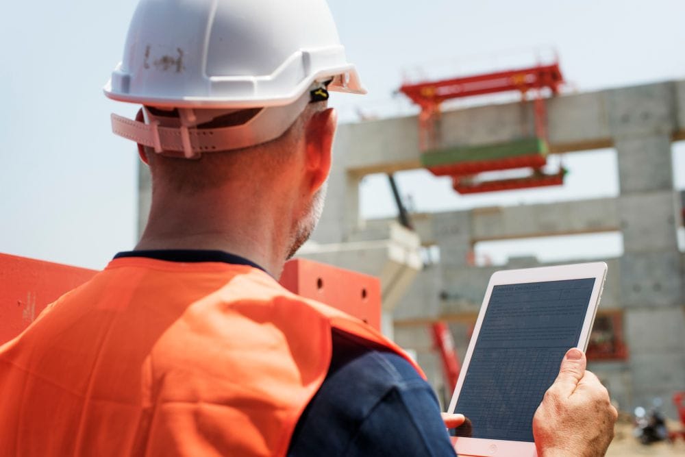 Construction worker reviewing project plans at a job site