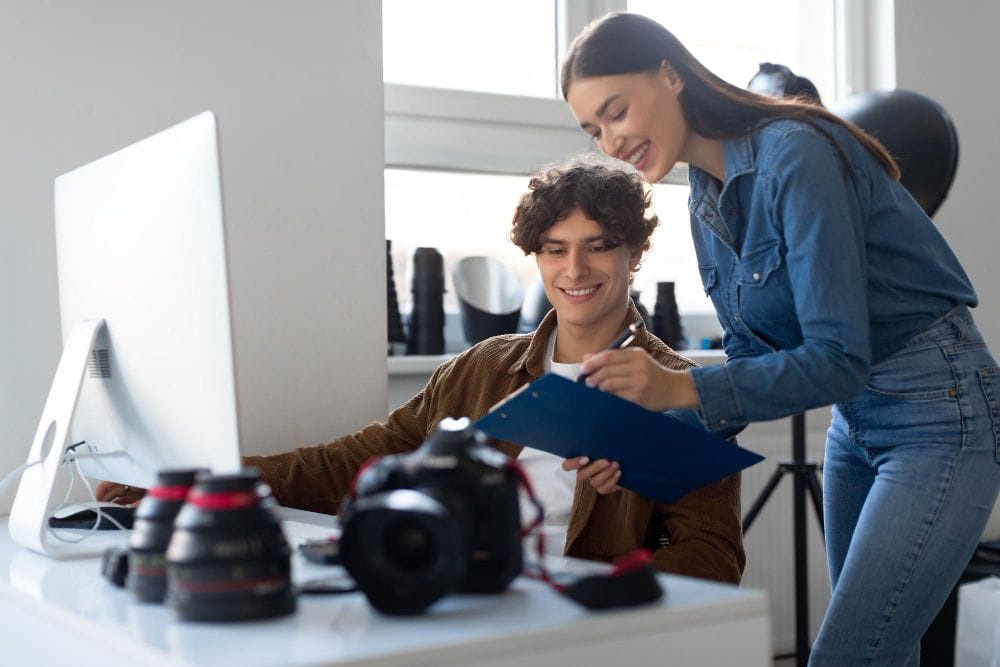 Photographer and assistant planning a studio photoshoot together
