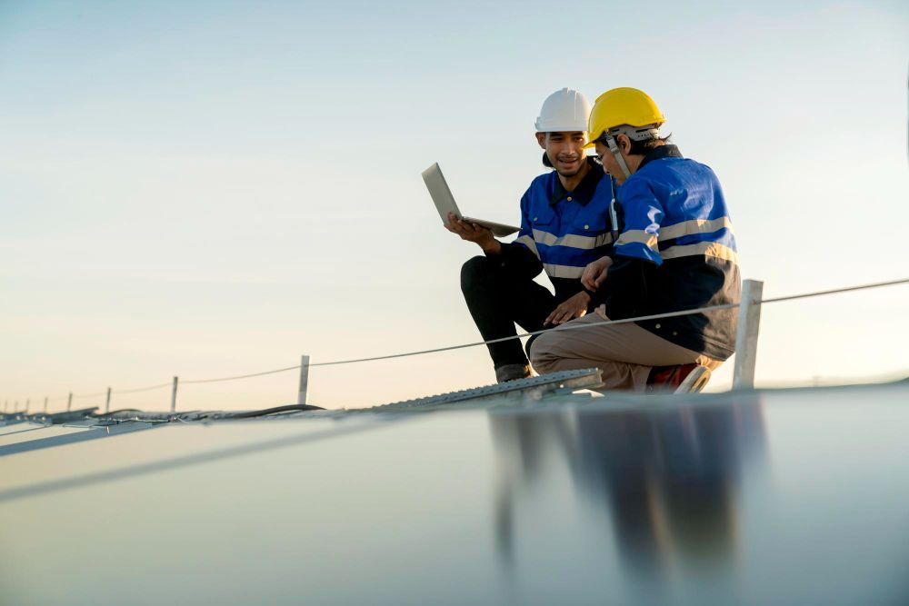 Technicians working together with a tablet on a rooftop
