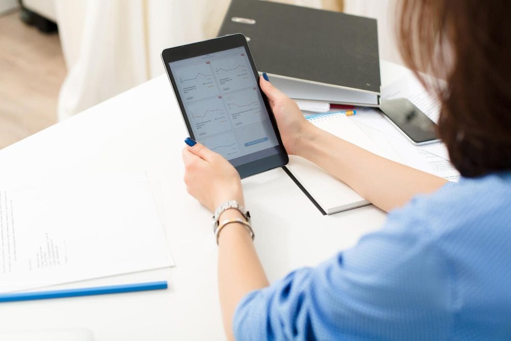Business professional using a tablet to manage work and appointments